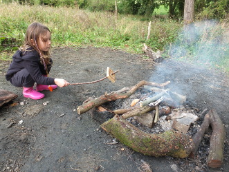 Toasting crumpet on Campfire